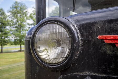 Headlight of old vintage locomotive train painted black with red elementsの写真素材