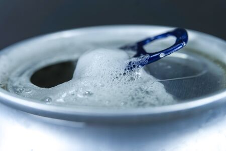 Opened can of beer or soda water. Close-up view from low angle with copy space