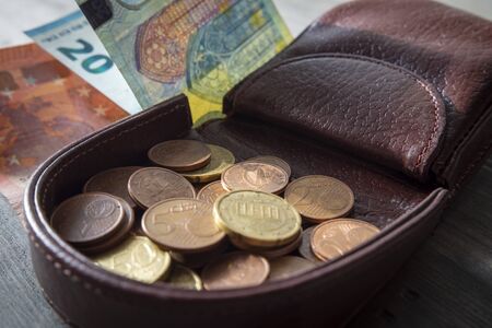 Euros coins change in open dark brown hard leather coin case tray purse or wallet and Euro...