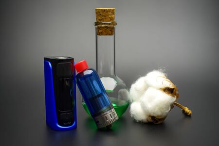 Electronic cigarette or vaping devices with natural cotton, cork stopped flask with vape liquidの写真素材