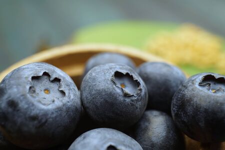 Macro shot of fresh ripe blueberry in wooden containerの写真素材