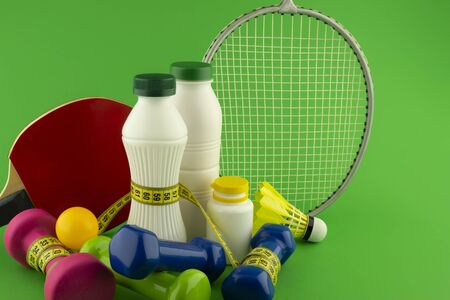 Table tennis, badminton sports and healthy nutrition concept still life on green chromakey background in close-upの写真素材