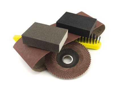 Set of different tools for grinding - sanding belt, metal wire bristle brush, abrasive sponge and flap disc for angle grinder, isolated on white backgroundの写真素材