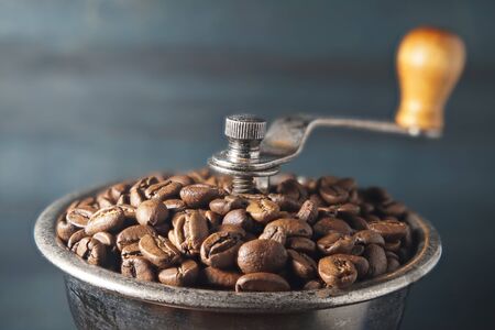 Close up coffee beans in manual coffee grinderの写真素材