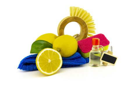 Home cleaning means, such as brush, cloth, foam sponge, acid and lemons for stain removal and freshness. Studio shot isolated on white backgroundの写真素材
