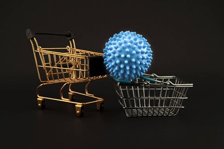 Blue virus molecule on a shopping cart and basket conceptual of the possibility of infection with corona virus or Covid-19 over a black backgroundの写真素材