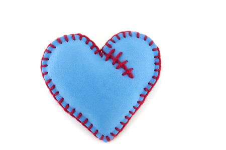 One handmade blue felt stitched toy heart on white background. Love, relationship, Valentines Day, broken heart conceptの写真素材