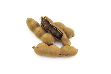 Heap of fresh whole tamarinds fruits isolated on white backgroundの写真素材