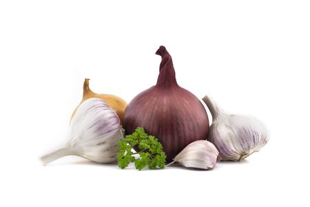 Garlic bulbs and cloves, green parsley twig, golden-brown and red onion isolated on white backgroundの写真素材