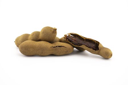Pile of fresh whole tamarinds fruits isolated on white backgroundの写真素材