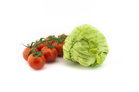 Fresh white cabbage and cherry tomato twig isolated on white backgroundの写真素材