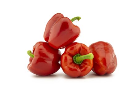 A stack of red bell peppers isolated on white backgroundの写真素材