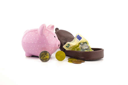 Open leather purse with crumpled banknotes, coins and cute pink piggy bank on white with copyspace for financial or savings conceptsの写真素材