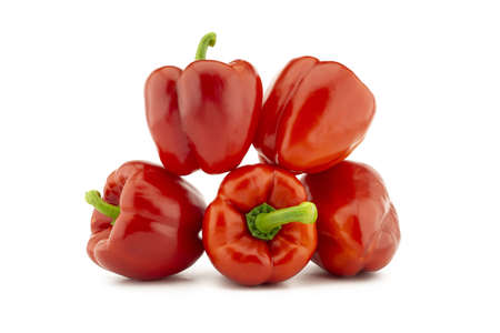A stack of red bell peppers isolated on white backgroundの写真素材