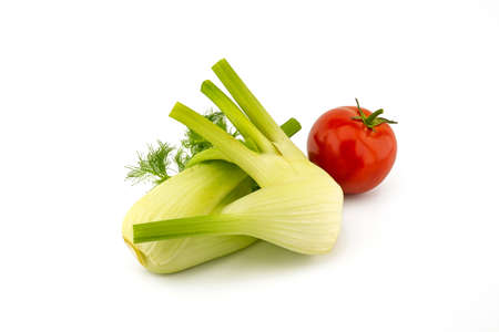 Fresh ripe red tomato and fennel over white backgroundの写真素材