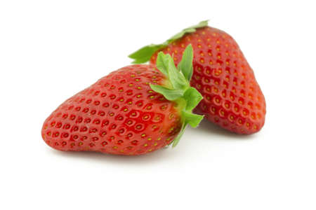 Two whole juicy ripe strawberries fruits isolated on white backgroundの写真素材