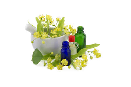 Fresh Linden or Tilia flowers and leaves with essential oil bottles in a therapeutic still life for alternative healingの写真素材