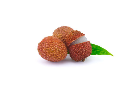 Lychee fruit whole and opened with green leaves decoration isolated on white backgroundの写真素材