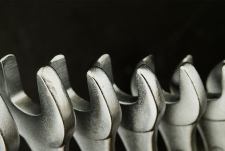 Set of spanners or wrenches in close up over a grunge stone background with free copy space