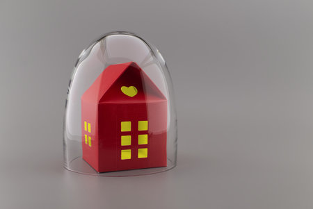 Red building with lights in the windows under protective shield as a concept of covid pandemic and self-isolationの写真素材