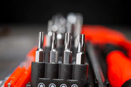Set of interchangeable screwdriver heads in selective focusの写真素材