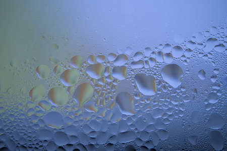 Water droplets or condensation on the outside of a cold window in a close up full frame background textureの写真素材