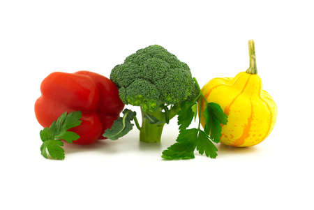 Fresh broccoli, red bell peppers, squash and sprig of parsley on white backgroundの写真素材