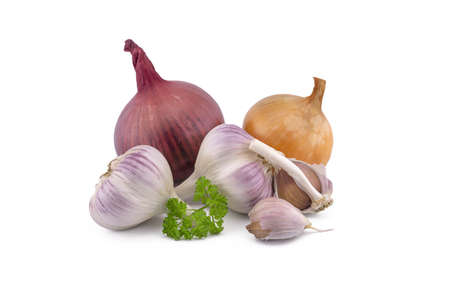 Different kind of onion, garlic bulbs and cloves, green parsley twig in close-up isolated on white backgroundの写真素材