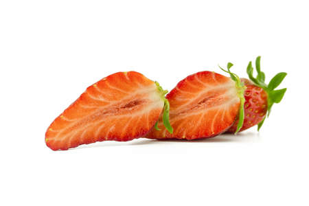 Ripe juicy strawberry fruit cut in half isolated on white backgroundの写真素材