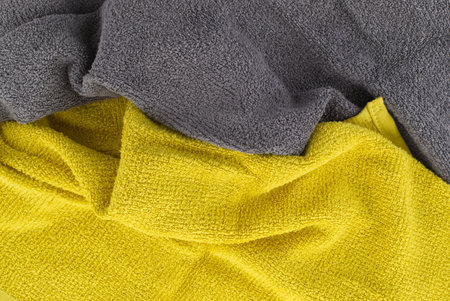 Two tone grey and yellow frote textile background with copy space viewed as a flat lay. Main color trend of the yearの写真素材