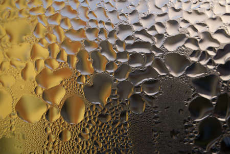 Water droplets or condensation on the outside of a cold windows in a close up full frame background textureの写真素材