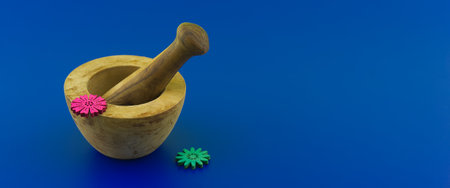 Wooden rustic style mortar and pestle. Spices and herb grinder over blue background with free space for textの写真素材