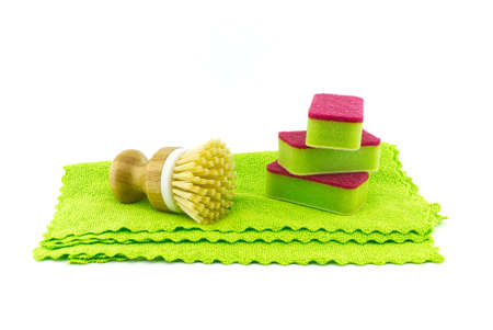 Multicolored cleaning sponges and dish brushes on microfiber cloth isolated on a white background. House cleaning suppliesの写真素材
