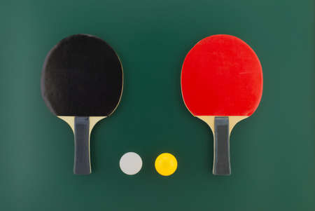 Table tennis equipment, racks and balls on green background with free copy spaceの写真素材