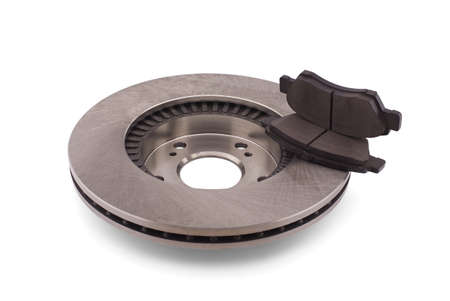 Car brake disc and brake pads isolated on white background. Auto spare parts - brake disc rotor and padsの写真素材
