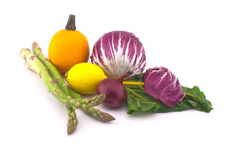 Assortment of fresh colorful including leaf beet, lemon, asparagus, radicchio salad, onion and garlic isolated on white backgroundの写真素材