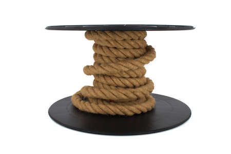 Braided natural jute rope wrapped on the reel isolated on white backgroundの写真素材