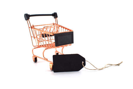 Black sale tag and golden shopping cart over white background. Black Friday sale, shopping conceptの写真素材