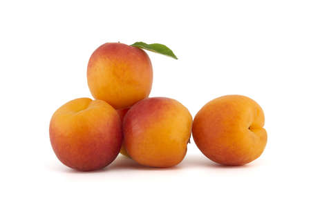 Pile of whole ripe apricots isolated on a white backgroundの写真素材