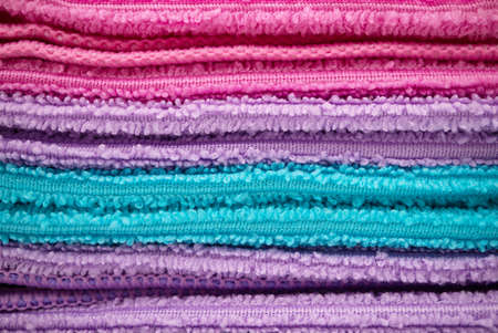 Stack of colorful beach or bathroom towels in closeupの写真素材