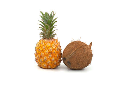 Whole pineapple fruit and coconut isolated on a white backgroundの写真素材