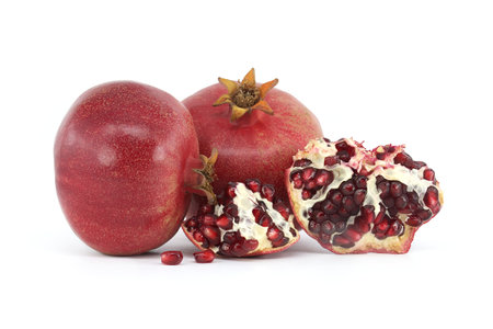 Red juice pomegranate fruits isolated on white backgroundの写真素材