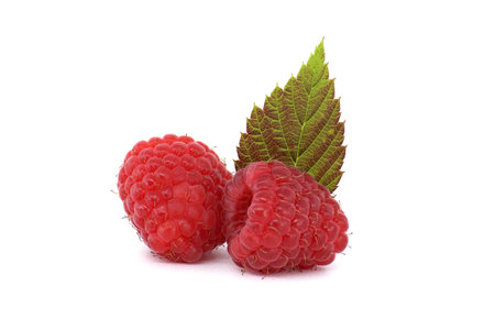 Red ripe raspberry berries with green leaves. Side view, isolated on white backgroundの写真素材