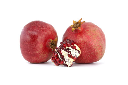Fresh ripe pomegranate fruits isolated on white backgroundの写真素材