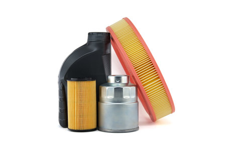 Vehicle engine round air filter, fuel and oil filters near motor oil can isolated on a white background. Car servicing and vehicle filters replacing maintenanceの写真素材
