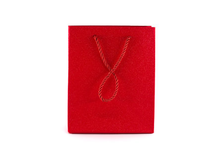 Red paper shopping bag isolated on white background. Gifts and shopping conceptの写真素材