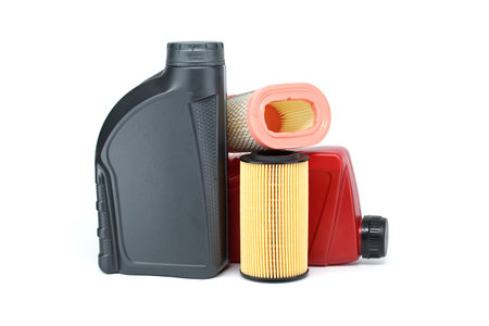 Motor oil filters elements oil and containers isolated on a white background. Car servicing, automotive industry and filter replacing maintenanceの写真素材