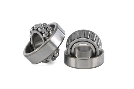 Ball bearings and tapered roller bearing isolated on white background. Car bearings, auto parts, automobile components for the engine and chassis suspensionの写真素材