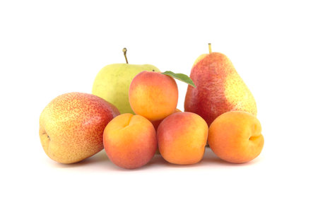 Whole ripe apricots, pear and green apple isolated on a white background, various fruits for a multivitamin mixの写真素材