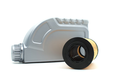 Vehicle engine oil filters elements and motor oil can isolated on a white background. Containers, plastic storage or oil and filter replacing maintenanceの写真素材